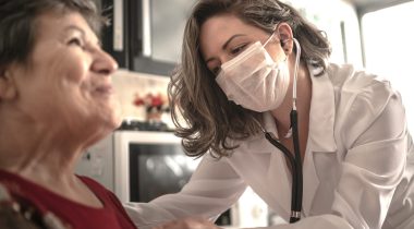 Health visitor and a senior woman during home visit